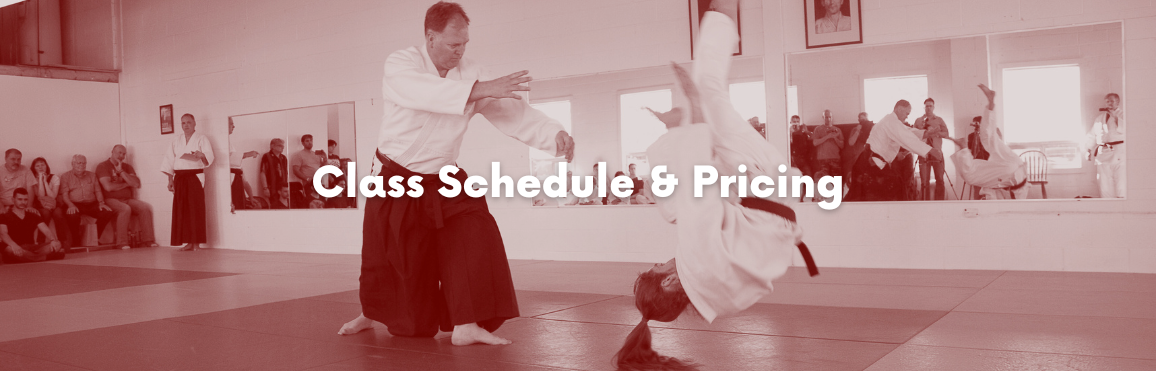 White text that reads “Class Schedule“ overlaid on a photo of people participating in an aikido class. 